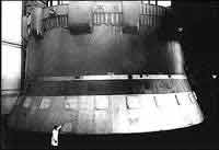 A worker in the foreground of the huge 1st stage